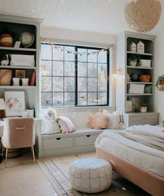 a bedroom with a bed, window seat and shelves filled with books on the wall