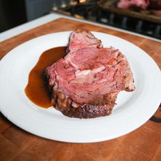 a piece of meat sitting on top of a white plate