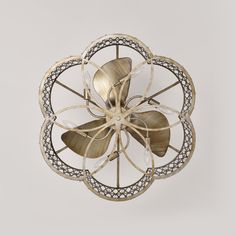 a decorative metal object on a white background with no people around it, including one large flower and two smaller ones in the center