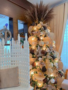 a white christmas tree with lights and decorations