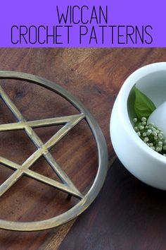 a white bowl with flowers in it next to a wiccan on a table