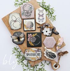 a wooden cutting board topped with lots of different types of paper and crafting supplies