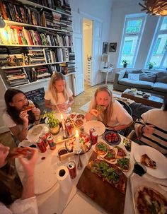 a group of people sitting around a table eating food