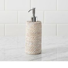 a soap dispenser sitting on top of a marble counter