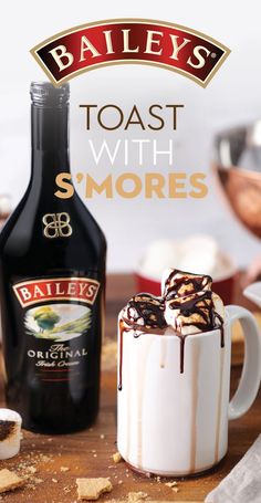 baileys toast with s'mores in a mug next to a bottle of booze