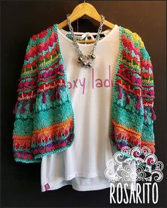 a white shirt with colorful crochet on it and a t - shirt that says roxy lad