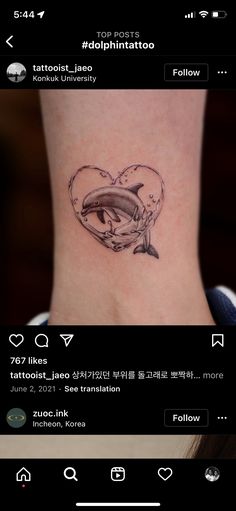 an image of a dolphin tattoo on the back of a woman's neck and chest