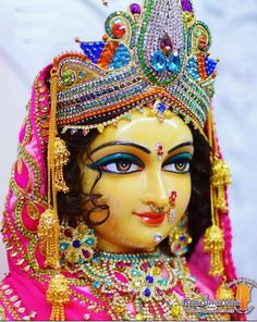 a close up of a statue of a woman wearing a headdress and jewelry