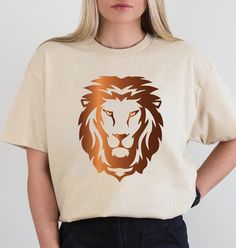 a woman wearing a t - shirt with a lion's head on it