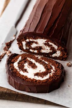 a chocolate roll with white frosting on top