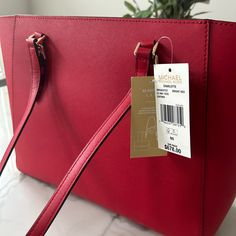 Brand New Mickael Kors Tote Double Handle Bags With Gold-tone Hardware As Gift, Designer Red Bag With Branded Hardware, Designer Red Bags With Branded Hardware, Classic Red Bag For Gift, Classic Red Bag With Branded Hardware, Designer Red Tote Bag, Classic Red Shopping Bag, Designer Red Shoulder Bag As Gift, Red Rectangular Shoulder Bag With Branded Hardware