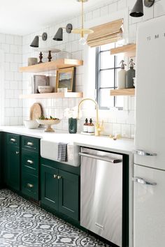 a kitchen with green cabinets and white tile