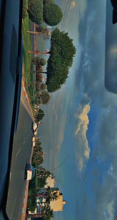 the reflection of clouds in the windshield of a car