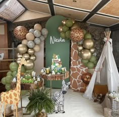 a giraffe and zebra themed birthday party with balloons, decorations, and food