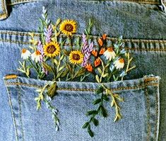 a pair of jeans with flowers in the back pocket