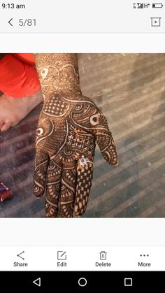 an image of someone's hand with henna on it