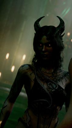 a woman with black makeup and horns on her head is standing in front of lights