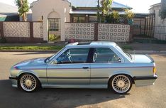 a silver car parked in front of a house