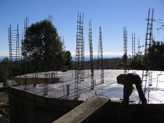 a man is working on the roof of a building with many scaffoldings