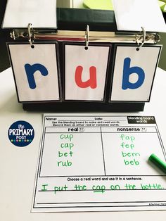 a binder with words that spell out the word rub on it next to a green marker