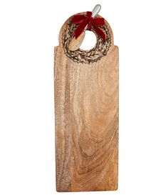 a wooden cutting board with a red bow on it's handle and an ornament