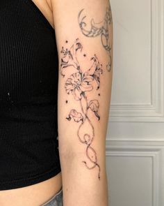 a woman with a flower tattoo on her arm