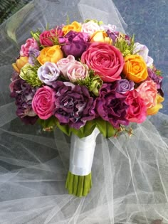 a bridal bouquet with purple, yellow and pink flowers