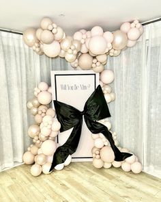 balloon arch with black ribbon and white balloons