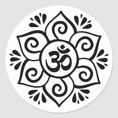 the symbol for yoga in black and white sticker on a round surface, with an om