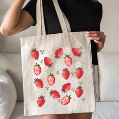 Carry your love for strawberries wherever you go with this adorable strawberry tote bag.Perfect for trips to the farmers market or as a cute gift for fellow strawberry lovers!.This 100% cotton bag comes in one size - 15" x 16"- perfect for everyday wear. While the canvas material will show off your designs in great colors, it's durable and will last for years. The bag features 20" handles (made from the same canvas), making it easy to carry even with a week's worth of shopping. Tote Bag Details:  * 100% cotton canvas * Heavy fabric (12 oz/yd² (406.9 g/m * Available in natural and black colors * Sewn-in label Key Features:  * 100% Cotton Canvas * Carrying Handles  * Flat Corners Care Instructions:  Do not iron directly over the printed area - print may stick to the iron.; Spot clean; Do not Pink Strawberry Print Bag As Gift, Red Bag With Strawberry Print As Gift, Rectangular Bag With Strawberry Print As Gift, Rectangular Strawberry Print Bag For Gifts, Rectangular Strawberry Print Bag As A Gift, Rectangular Bags With Strawberry Print As Gift, Rectangular Bags With Strawberry Print For Gifts, Cute Strawberry Print Tote Bag, Cute Strawberry Print Bags For Everyday Use