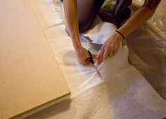 a person cutting paper on top of a table