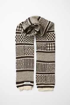 The Sockstole Scarf is an everyday scarf ideal for those crisp days where a simple sweater and coat just won't do. Double-layer construction lets you enjoy the colder months of the year without a single shiver. A Fair Isle print adds a rugged touch to the look. Made from a blend of acrylic, nylon, and wool that's cozy, lightweight, and durable. Choose from Ivory/Black, Red, or Greyish Brown. Specifications: Unisex Made from 60% Acrylic, 20% Cotton, 12% Silk, 6% Nylon, 2% Wool Measures approximat Simple Sweater, Simple Sweaters, Greyish Brown, Wool Gloves, Denim Hat, Months Of The Year, Wool Trousers, Months In A Year, Casual Bags