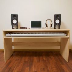 a computer desk with headphones and a keyboard