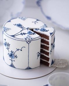 a white and blue cake with one slice cut out