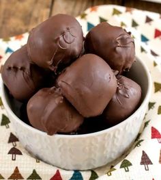 a white bowl filled with chocolate candies on top of a table