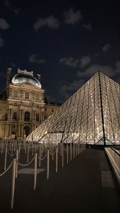 the glass pyramid is lit up at night