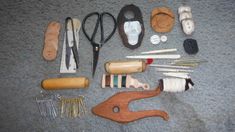 an assortment of sewing tools laid out on the floor