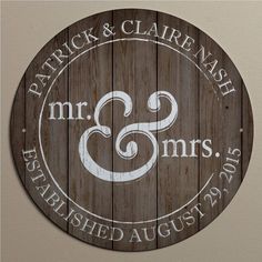 a wooden sign with the words mr and mrs engraved in white on it's side