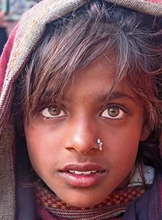 a close up of a person with a nose ring