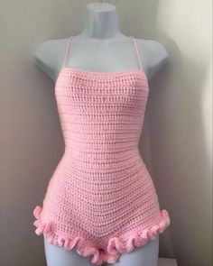 a pink crochet swimsuit on a mannequin