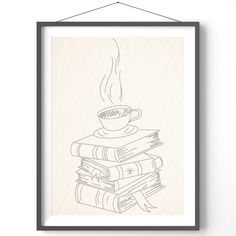 a stack of books with a cup of coffee sitting on top of each other in front of a white wall