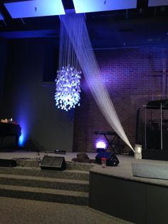 the stage is set up for an event with chandelier hanging from the ceiling