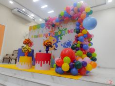 there are many balloons and cake on the stage set up for an event or celebration