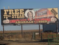 a large billboard with an image of a football player on it's side in the middle of nowhere