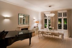 a living room filled with furniture and a piano