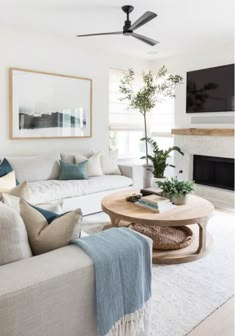 a living room filled with furniture and a flat screen tv mounted on the wall above a fireplace