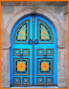 an ornate blue door with yellow and orange designs