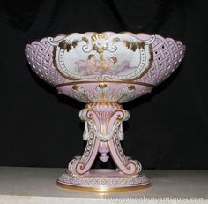 an ornate pink and gold vase on display