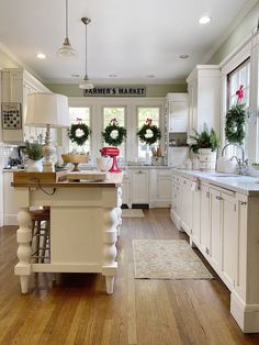 the kitchen is decorated for christmas with wreaths