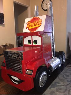 a red truck with a box on the back of it's head and eyes